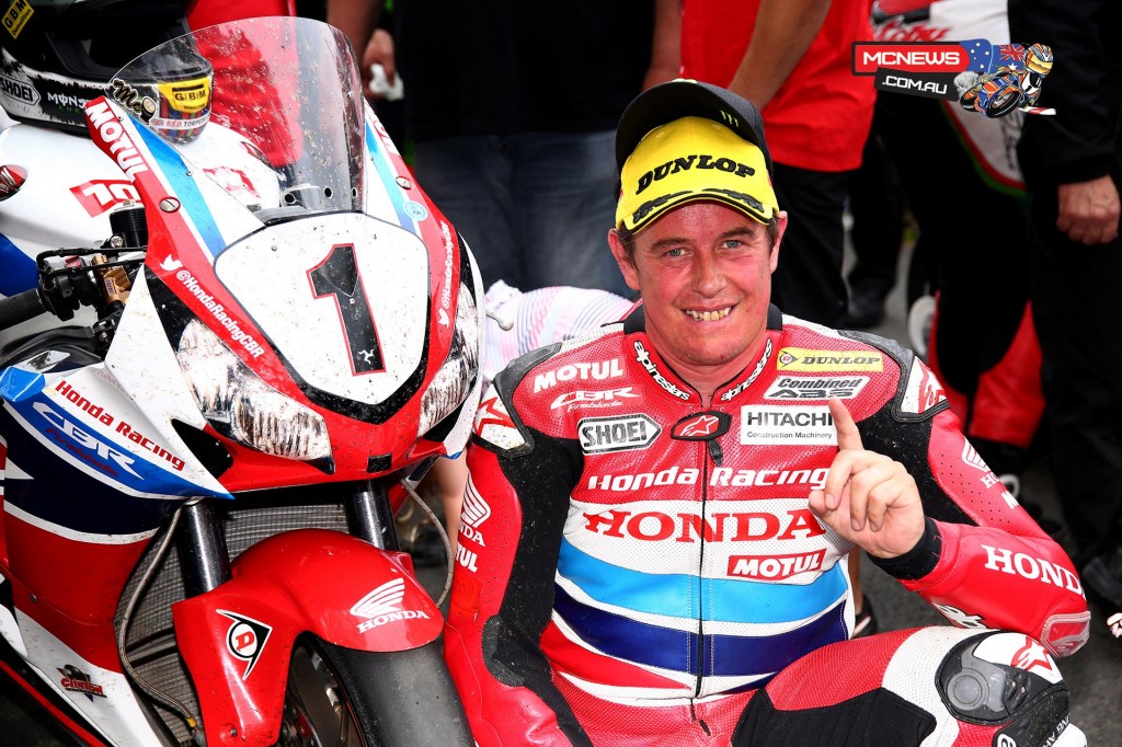 John McGuinness celebrates his seventh Senior TT victory in the winners enclosure for the 2015 PokerStars Senior TT podium. Credit Tim Keeton/Impact Images Photography