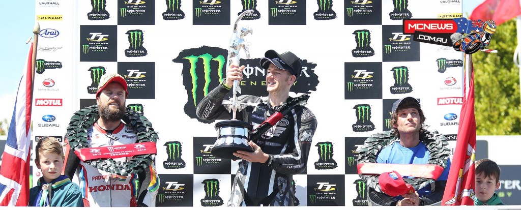 Ian Hutchinson hoists the TT trophy on the podium of the Monster Energy Supersport Race 2. Credit Stephen Davison/Pacemaker Press Intl.