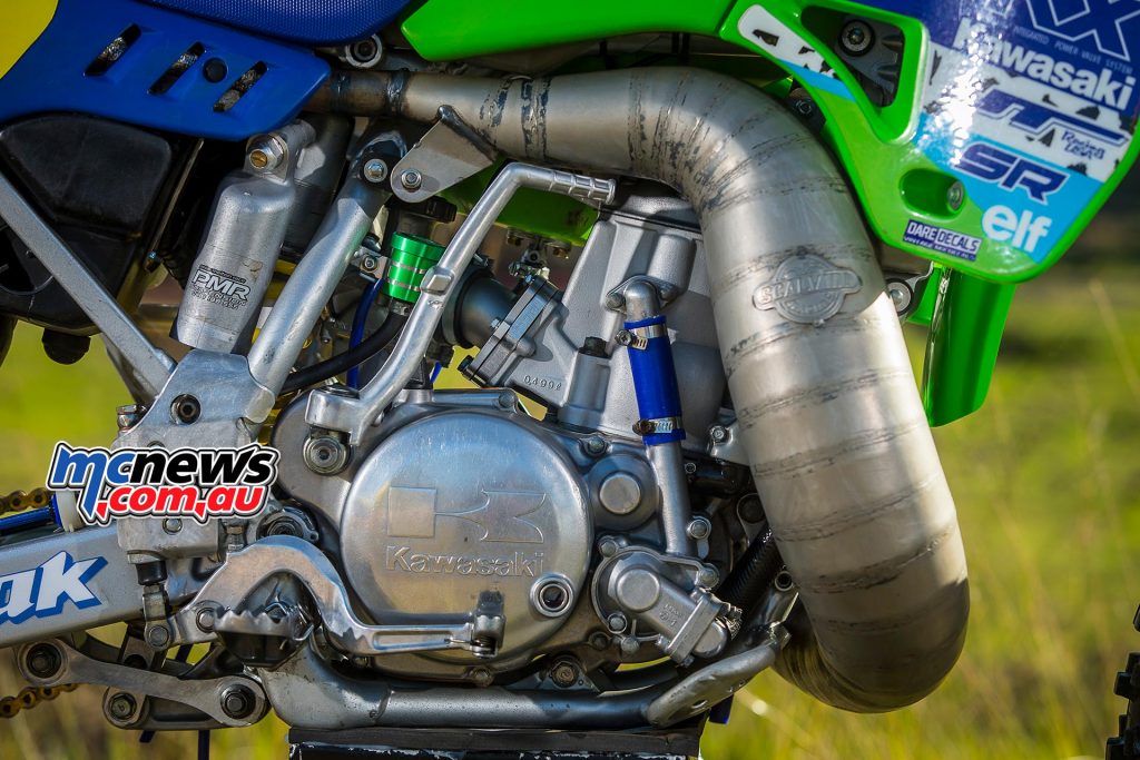 1989 Kawasaki KX500 - Brad Mustard - Image by Greg Smith - A boysen reed block and Moose Alloy spacer help the engine breathe and let the rider get on with more important things than slipping the clutch to get it out of the turns! Stuff like holding on with your arms, shoulders and butt cheeks..