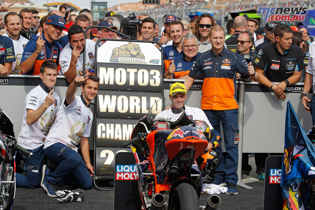 The Red Bull KTM Ajo team with Brad Binder celebrate in the pits.