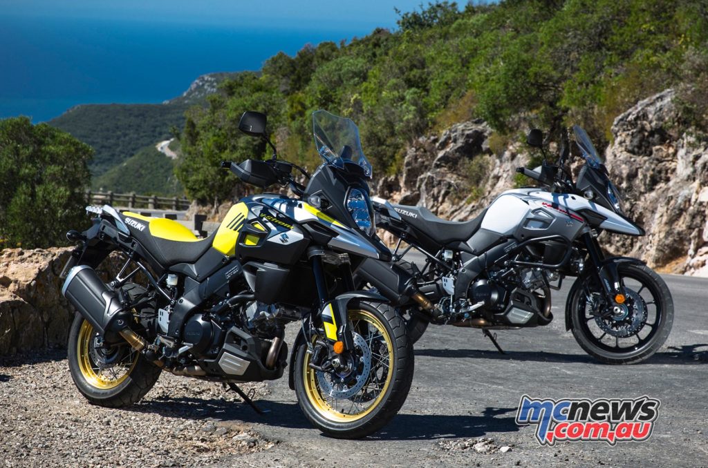 The 2017 Suzuki V-Strom 1000XT (front - yellow, spoked wheels) and V-Strom 1000 (back- white cast wheels).