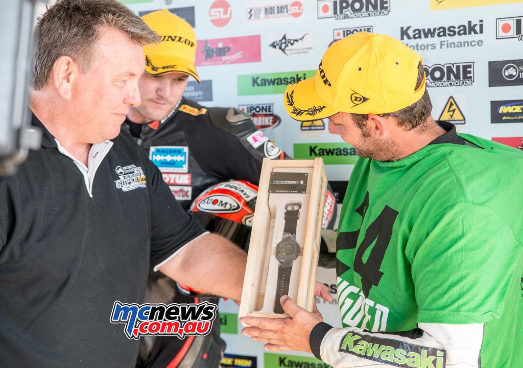Swann Superbike promoter Terry O'Neill hands Robbie Bugden his SevenFriday watch prize along with his trophy for taking out round five of the 2016 Swann Superbike Championship at Queensland Raceway recently