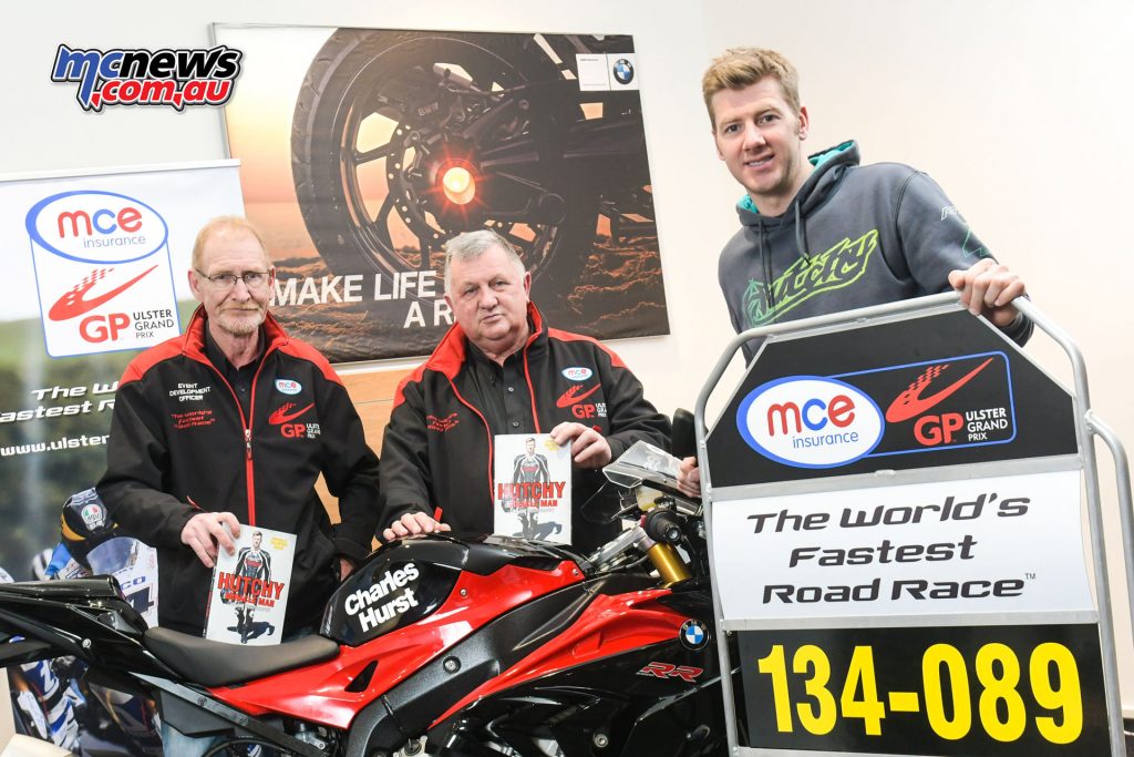 L-R: Ken Stewart and Eddie Johnston, Dundrod & District Motorcycle Club with the 2016 MCE UGP Man of the Meeting, Ian Hutchinson at his book signing at Charles Hurst BMW Motorrad on 3rd December.