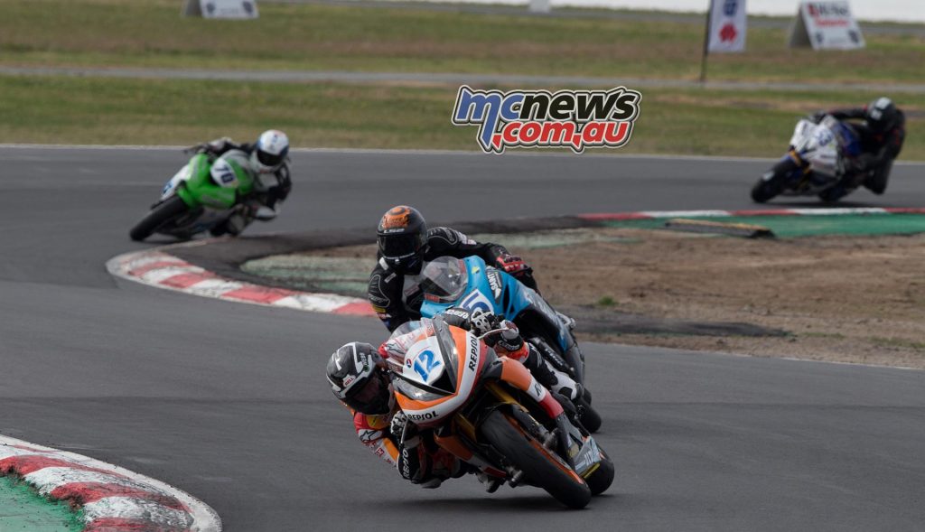 Mark Chiodo leads Ted Collins on lap two at Winton