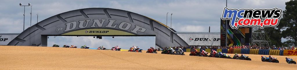 MotoGP riders streak under the Dunlop bridge at Le Mans