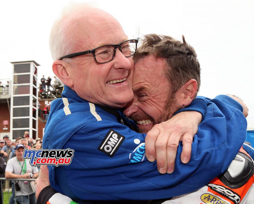 Clive Padgett hugs Bruce Anstey after his record-setting win in the Dunlop Lightweight Classic TT Race. Photo Stephen Davison / Pacemaker Press Intl
