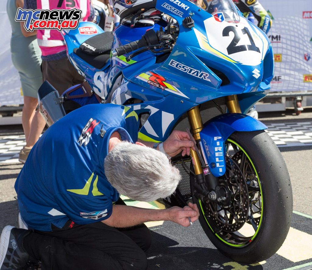 The bike is not even out of Parc Ferme before Phil Tainton is measuring how much fork travel Josh used in that race as they look towards improving the set-up further in race two - Image by TBG