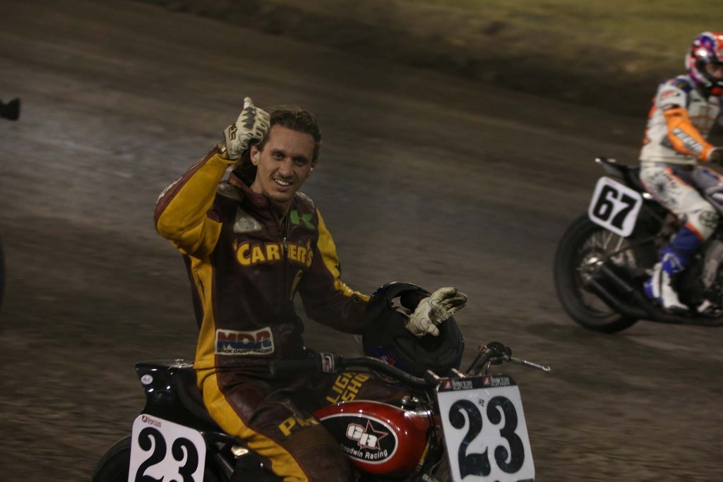 Excitedly taking the checkered flag Carver proudly takes the victory lap on his XR Photo Scott Hunter