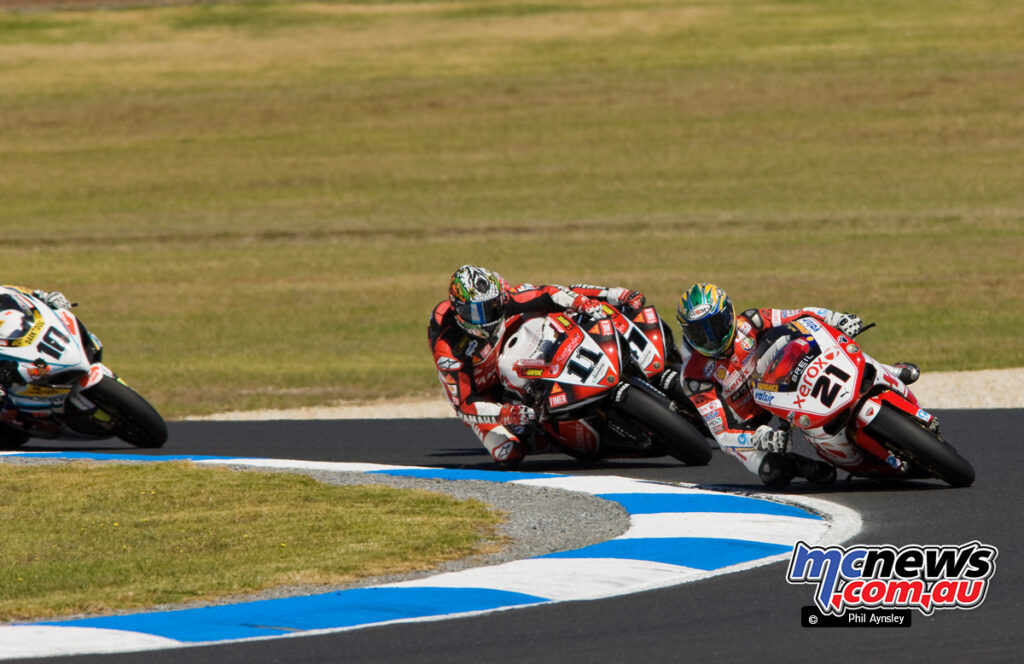 Troy Bayliss leads Troy Corser on the opening lap.