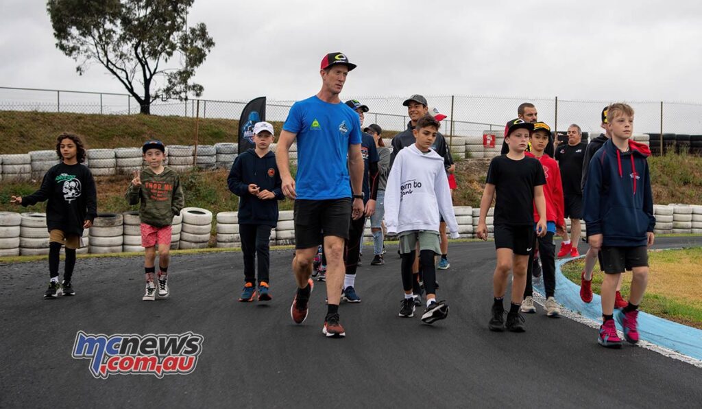 Wayne Maxwell walking the track with the young hopefuls at round one - 2022 FIM MiniGP Australia Series - Image RbMotoLens