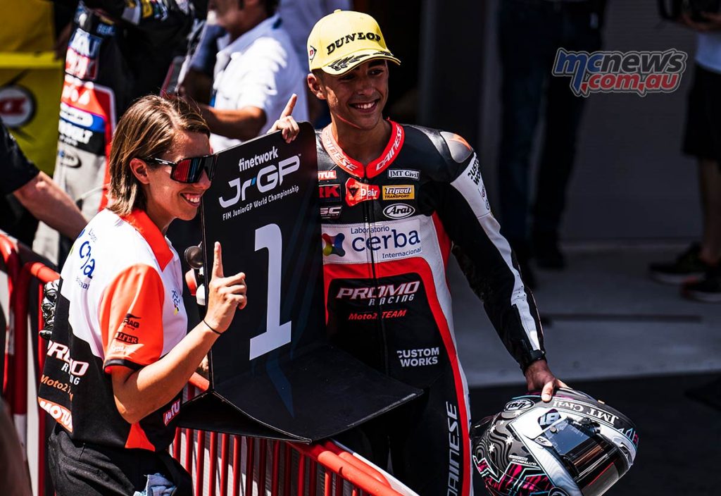 Senna Agius holding the #1 board with Stephanie Redman after taking his second win for the weekend in the FIM JuniorGP Moto2 European Championship