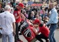 Miller and Bagnia up on stage creating live memorabilia