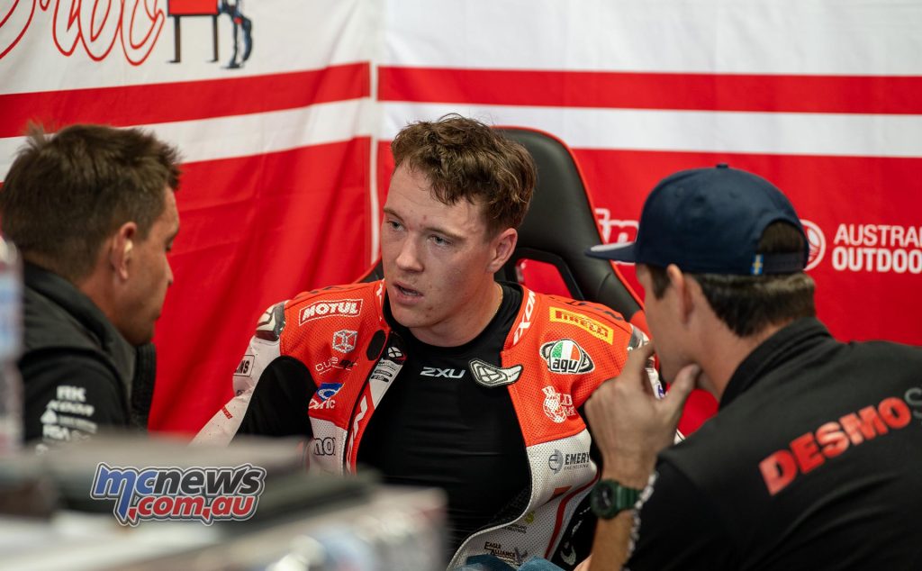 Broc Pearson discusses progress with DesmoSport Ducati Team boss Ben Henry and suspension tech Byron Draper - Image RbMotoLens