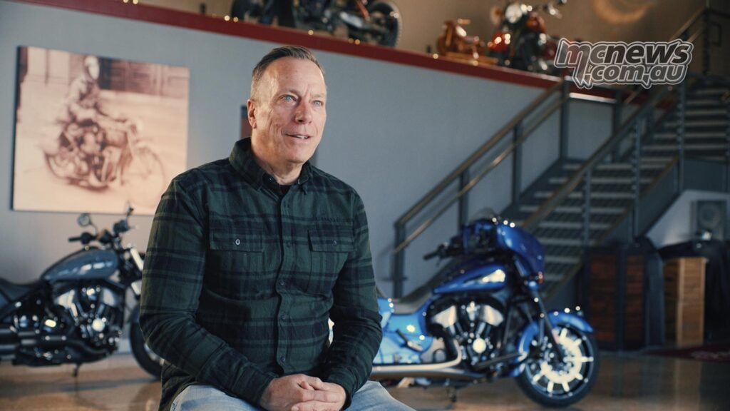 Indian Motorcycle CEO Mike Kennedy seated in front of motorcycles inside a showroom