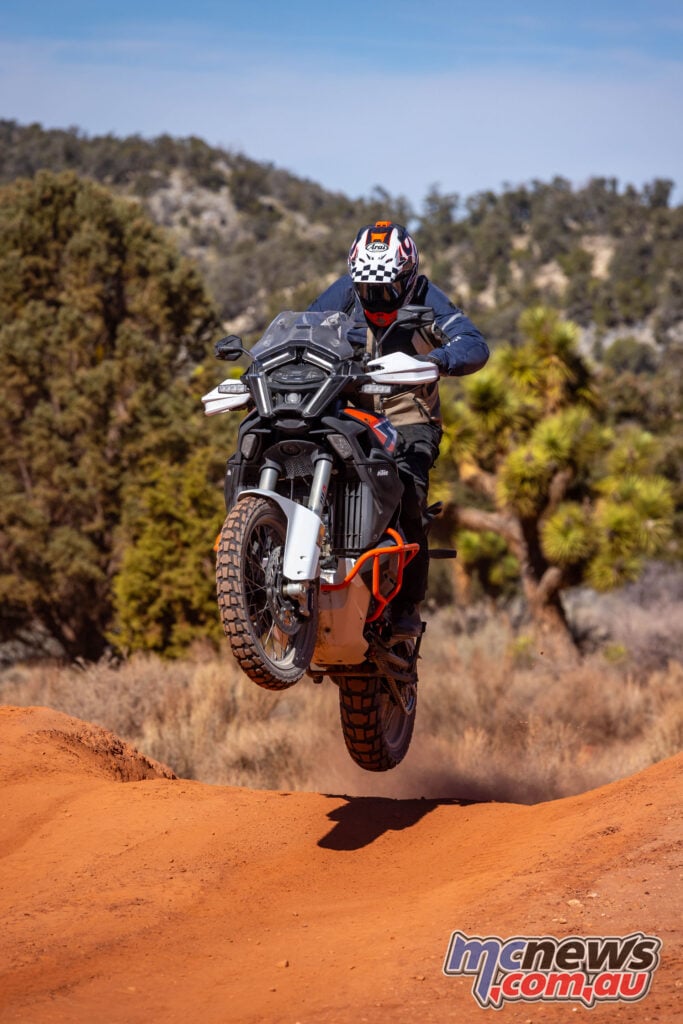KTM 1390 Super Adventure R airborne over a desert rise during off-road ride