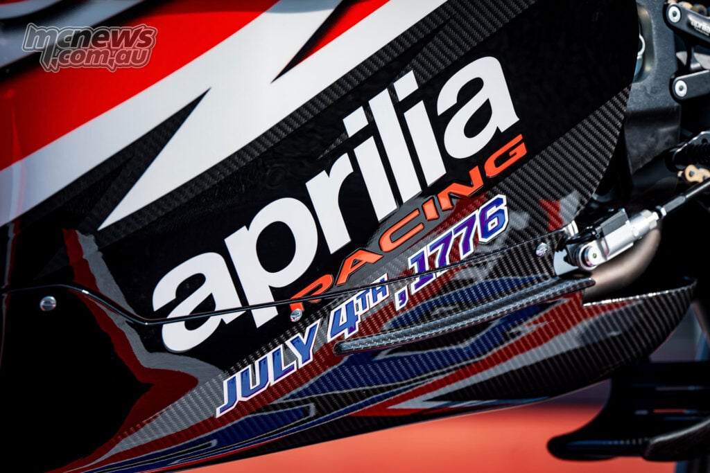 Close-up of the Aprilia X 250TH fairing showing Aprilia Racing branding and July 4th 1776 anniversary graphics.