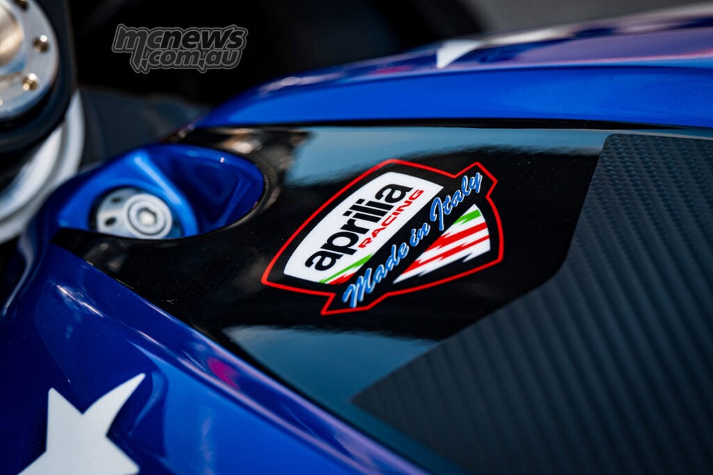 Close-up of the Aprilia Racing Made in Italy badge on the blue fairing of the X 250TH.