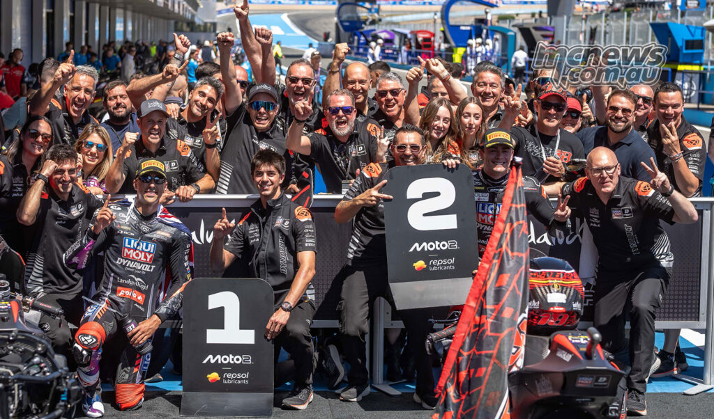Senna Agius celebrates with the Intact GP team in parc ferme after winning Moto2 at Jerez.
