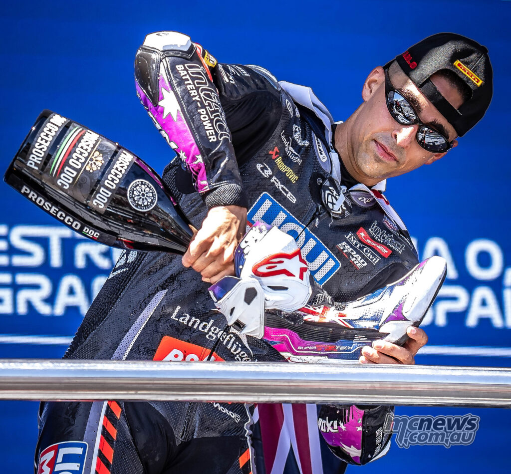 Senna Agius pours a drink into his boot during the Moto2 podium celebration at Jerez.