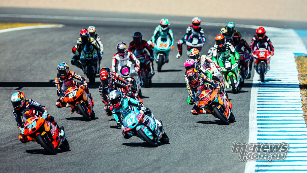 Valentin Perrone leads Marco Morelli and several riders during the Moto3 race at Jerez.