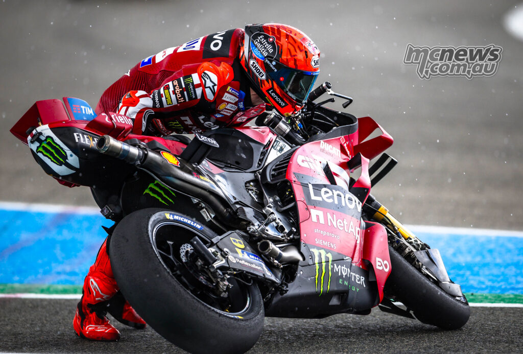Marc Márquez remounts his Ducati after crashing in the rain-hit Jerez Sprint.