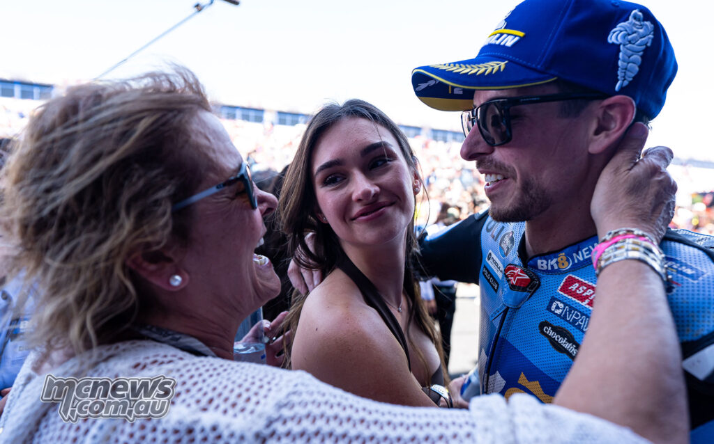 Alex Marquez smiles and embraces family members in parc ferme after winning the Spanish Grand Prix.