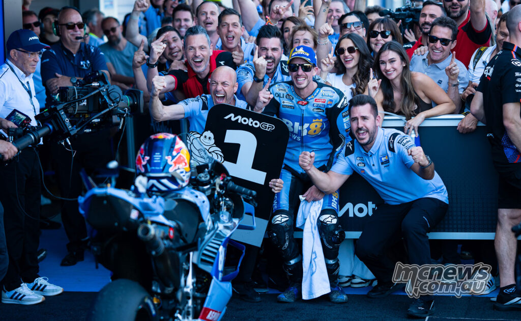 Alex Marquez poses with the number one board and the Gresini team in parc ferme after winning the race.
