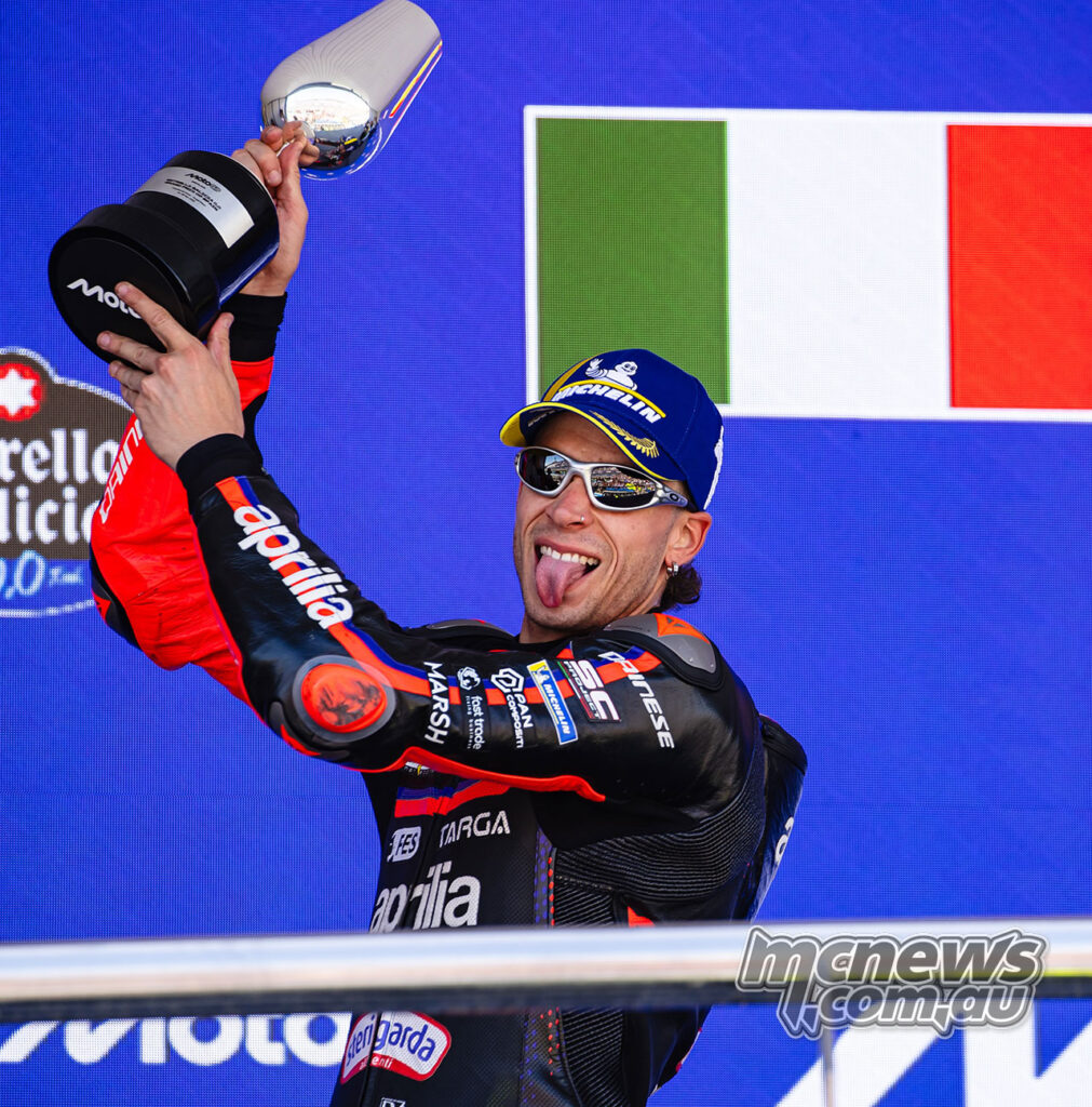 Marco Bezzecchi smiles with his podium trophy after finishing second in the Spanish Grand Prix.