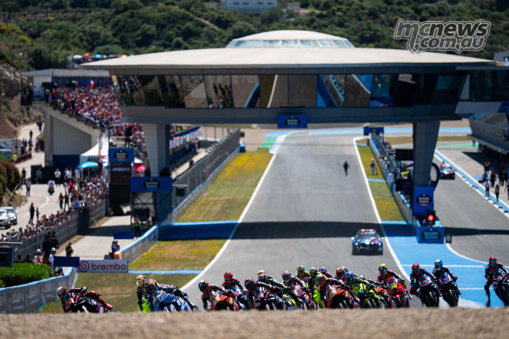 The full MotoGP field bunches up under braking into Turn 1 at Jerez at the race start.