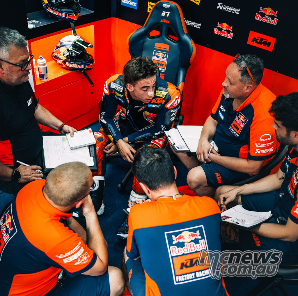 Pedro Acosta sits in the Red Bull KTM pit box speaking with engineers during the Jerez MotoGP test.