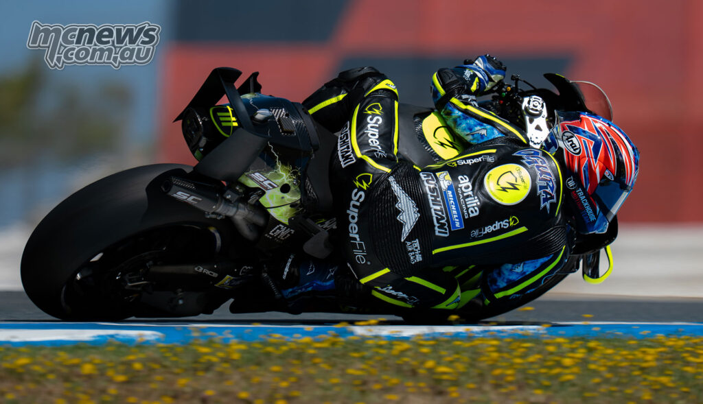 Rear three-quarter view of Ai Ogura leaning through a right-hand corner on the Trackhouse Aprilia.