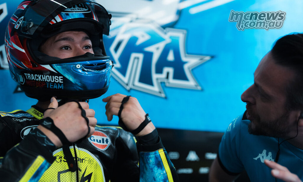 Ai Ogura fastening his helmet in the Trackhouse garage at Jerez.