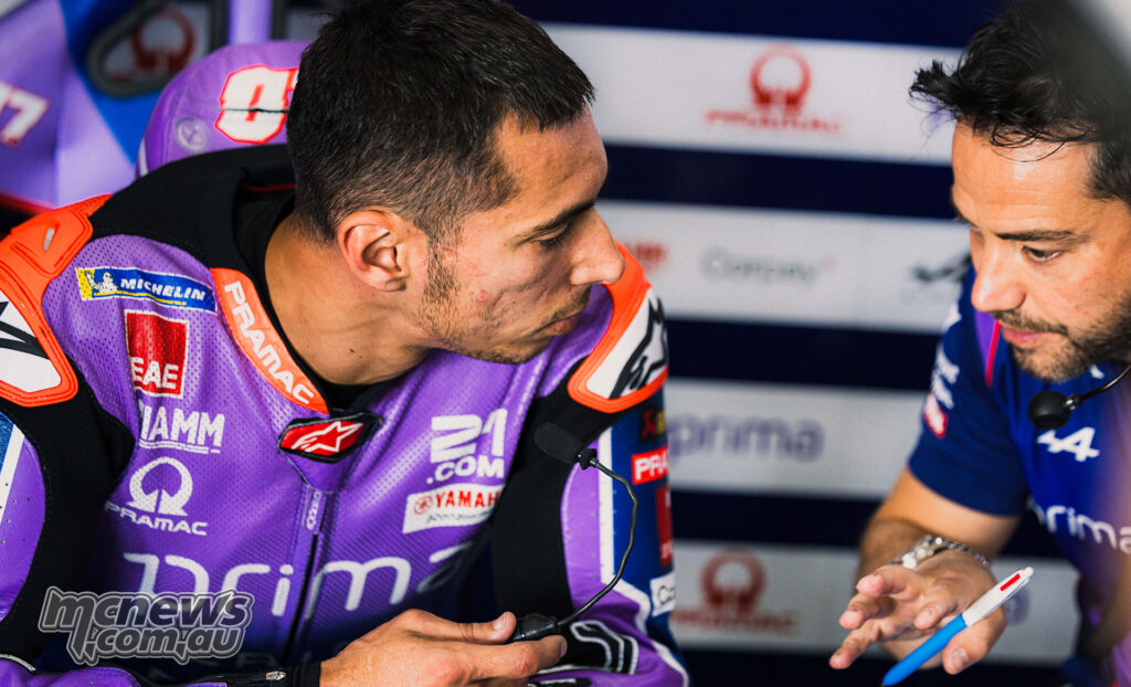 Toprak Razgatlıoğlu talking with a team engineer in the garage at Jerez.