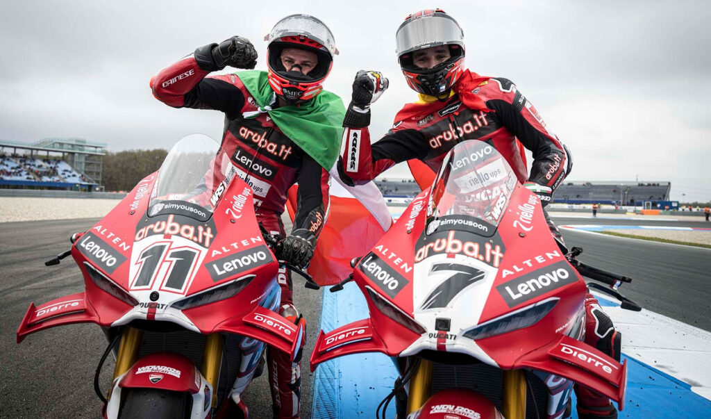 Nicolò Bulega and Iker Lecuona pose with their Aruba.it Ducati superbikes after finishing first and second in WorldSBK Race 1 at Assen.