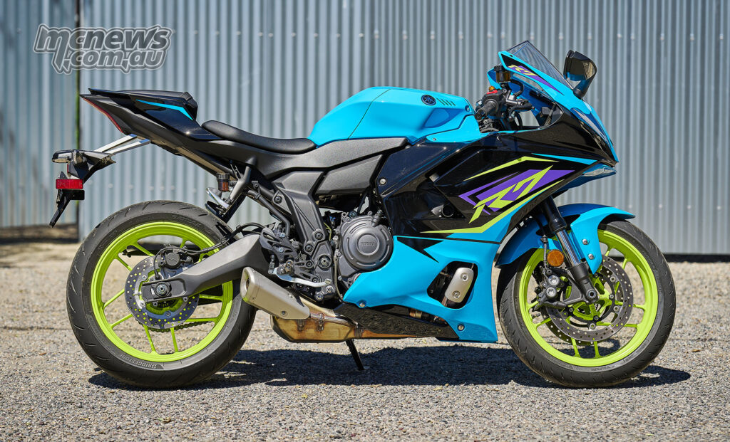 Cyan 2026 Yamaha YZF-R7 in full side profile parked on gravel.