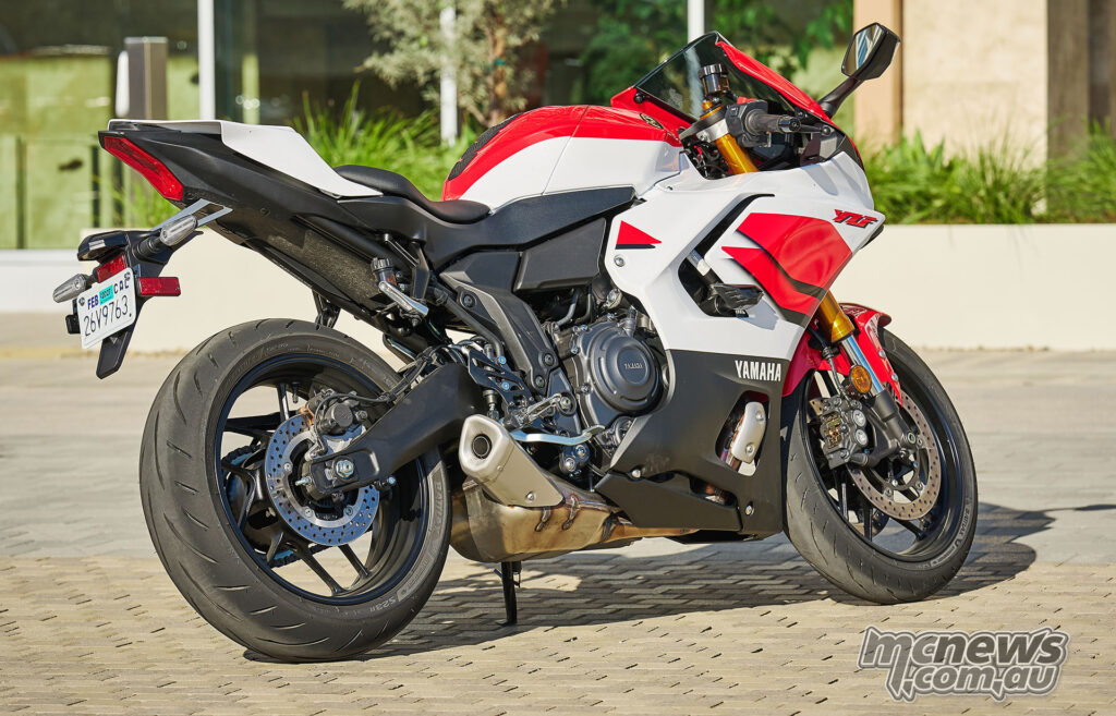 White and red 2026 Yamaha YZF-R7 parked in rear three-quarter view.