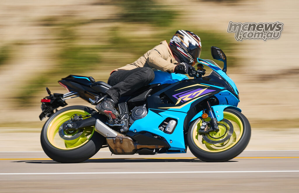 Cyan 2026 Yamaha YZF-R7 in side-profile panning shot on road.