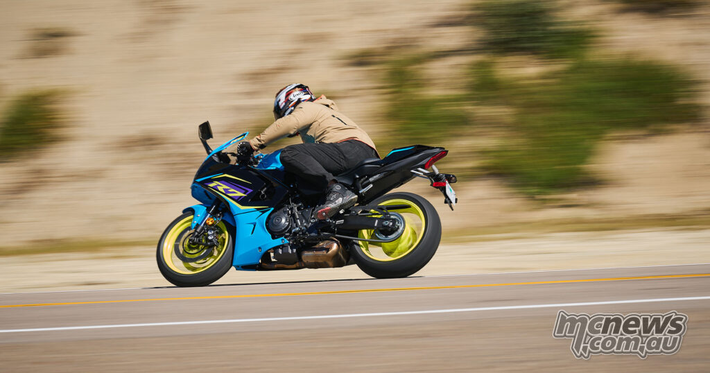 Blue 2026 Yamaha YZF-R7 in panning action shot on open road.