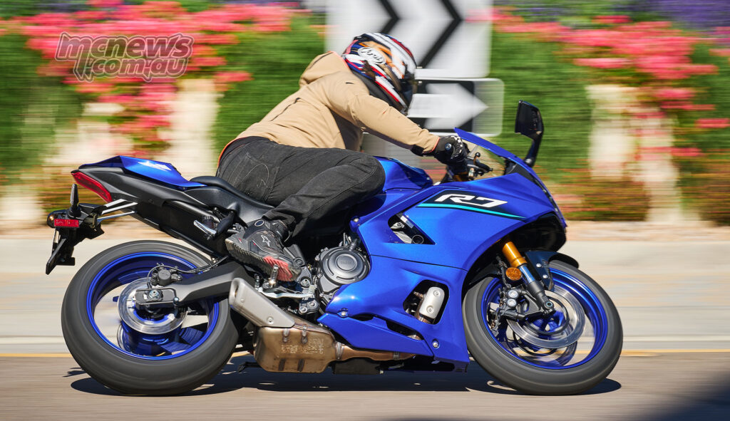 Blue 2026 Yamaha YZF-R7 in side-profile action shot on road.