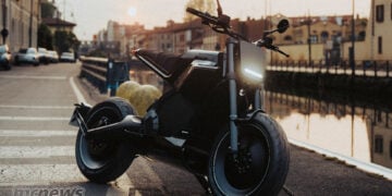 Black DAB 1a BRABUS electric motorcycle parked beside a canal in Milan