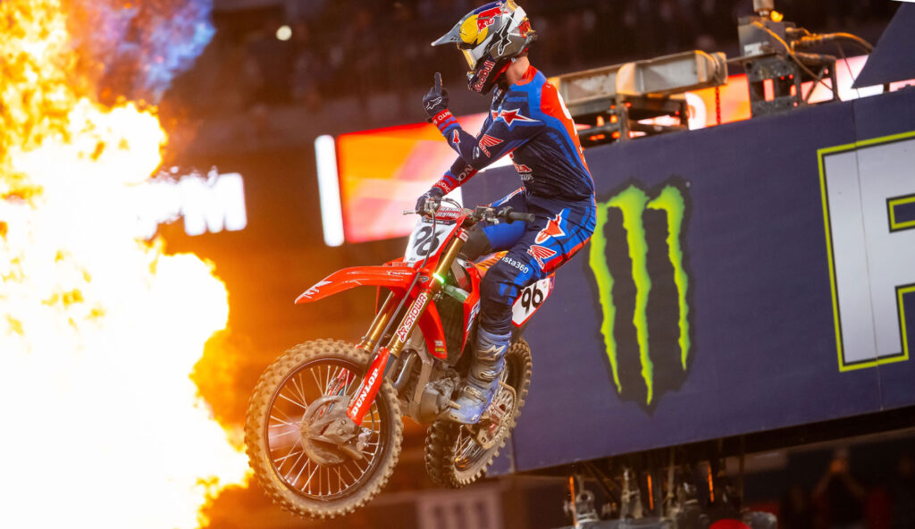 Hunter Lawrence crossing the finish line in front of flames after winning the Denver 450SX Main Event.