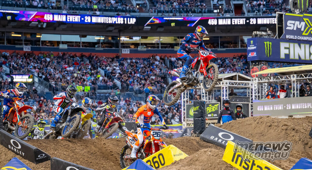 Start of the Denver 450SX Main Event with the field launching from the gate under pyrotechnics.