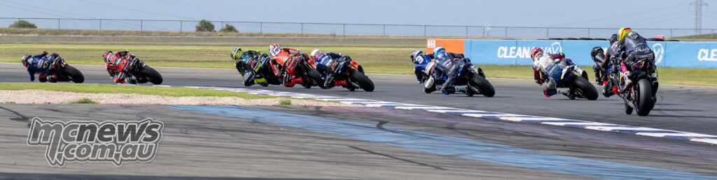 ASBK Superbike riders lean through the opening lap of Race One at The Bend