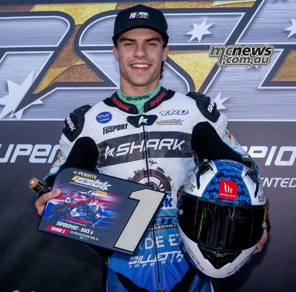 Jake Farnsworth holding the Supersport Race One winner’s trophy at The Bend