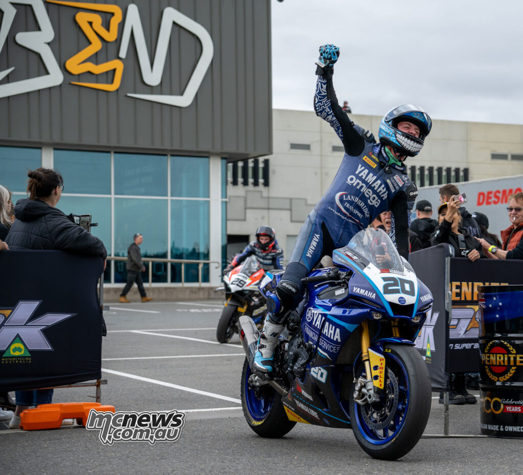 Jonathan Nahlous celebrates in parc fermé after finishing third in ASBK Superbike Race Two