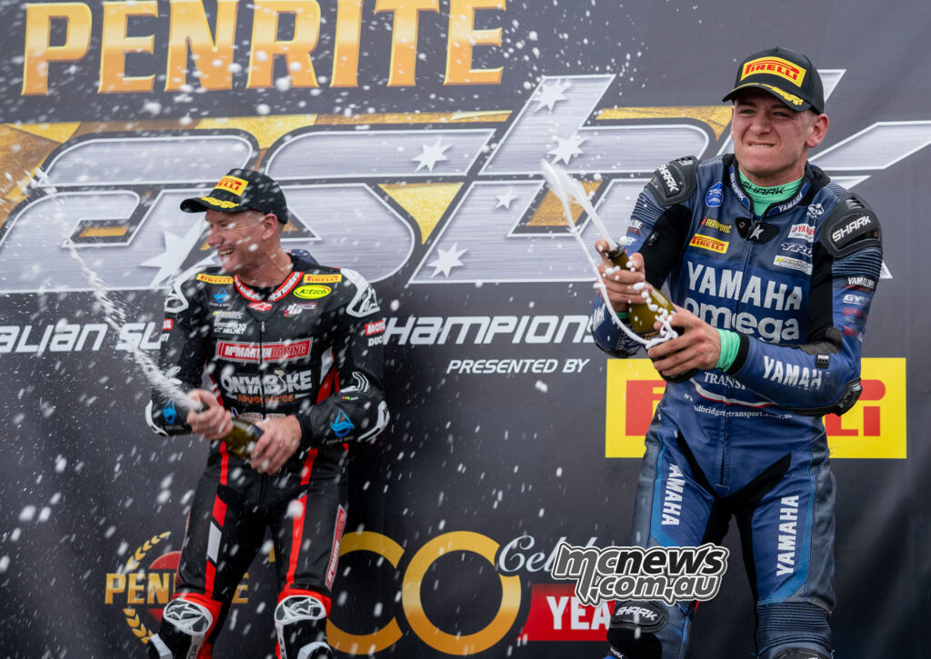 Josh Waters and Jonathan Nahlous spraying champagne on the ASBK Superbike podium