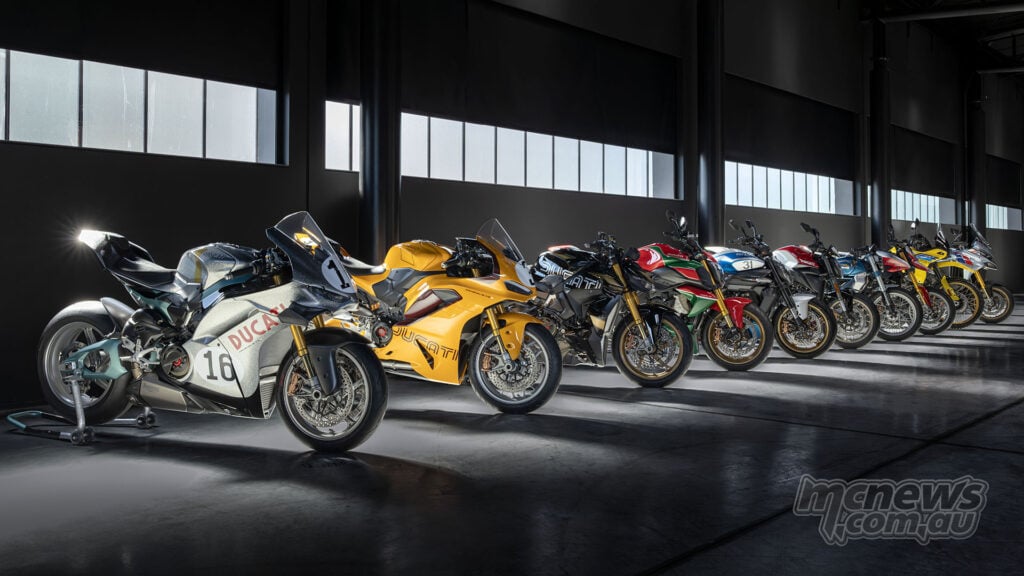 Ducati Collection 100 motorcycles arranged in a dramatic studio lineup, showing the range of anniversary liveries across the ten-model collection.