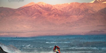 Daniel Sanders rides his Red Bull KTM rally bike through rocky terrain with mountains in the background during stage five of the Desafío Ruta 40.
