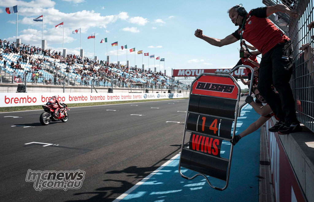 Nicolo Bulega takes the chequered flag as the Ducati pit wall celebrates his WorldSBK Race 1 victory at Balaton Park.