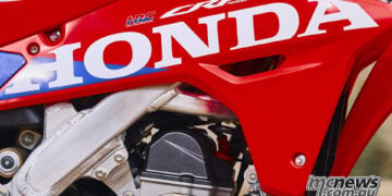 Close-up of Honda and HRC graphics on the red shroud of the 2027 CRF450R